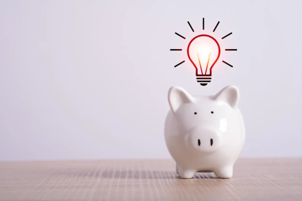 White piggy bank with an idea lightbulb graphic floating above